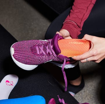best Shoe Inserts a person putting a shoe insert into their shoe