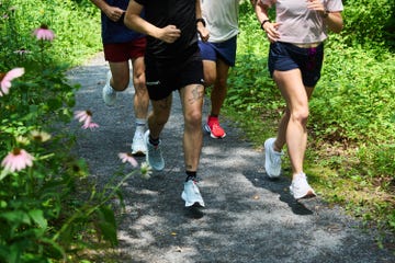 a group of people running on a path