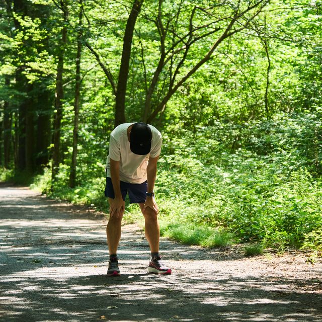a runner with hands on his knees after a hard effort