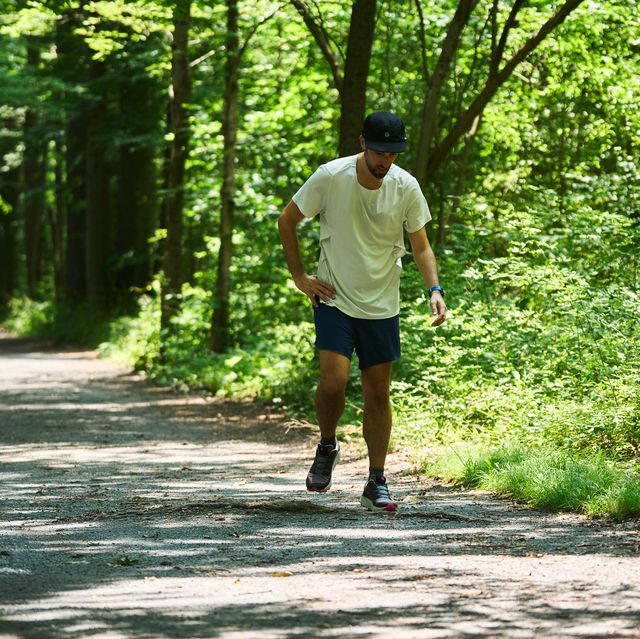 a runner looking tired after a run on a gravel trail