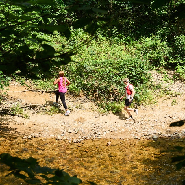 two people running on a dirt path