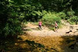 two people running on a dirt path