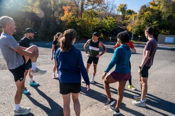 group of individuals participating in a warmup stretching session outdoors