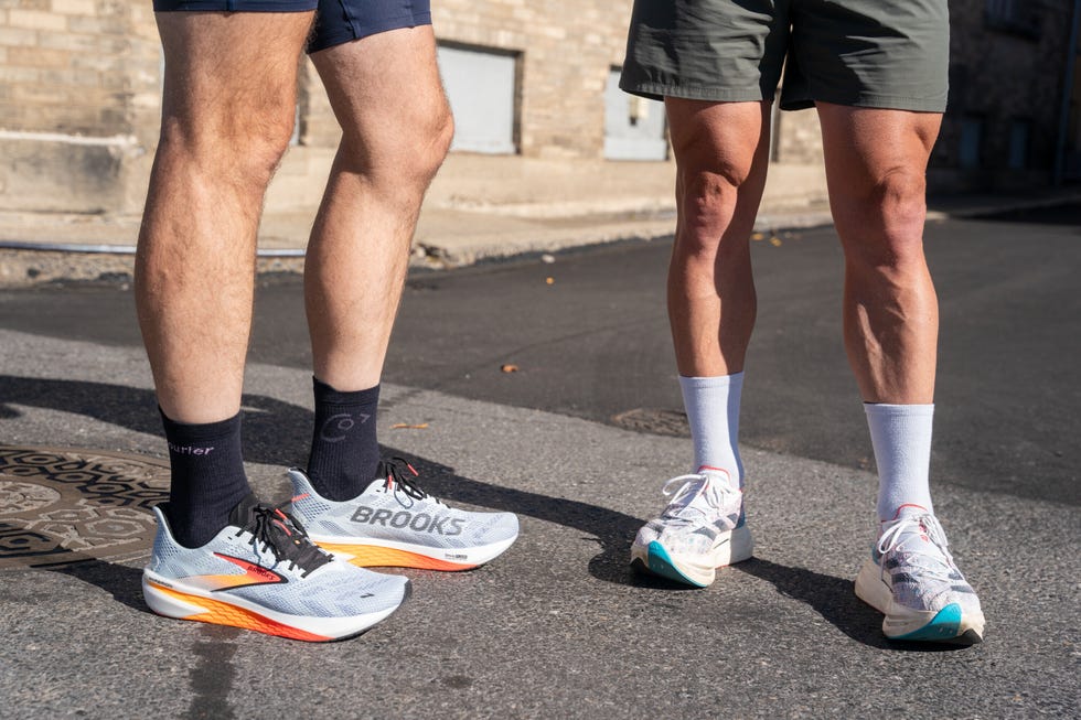 two runners standing on road in brooks and adidas running shoes