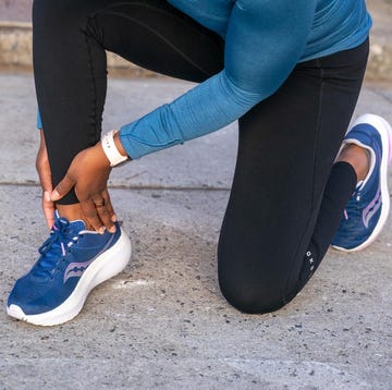runner holding ankle and Achilles runner holding ankle and achilles