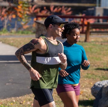 RWD Two individuals running in a park