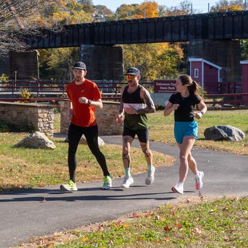 three runners on a park path in the fall. three runners on a park path in the fall.