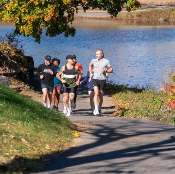 group of runners along a path beside a body of water group of runners along a path beside a body of water