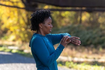 person checking a smartwatch while standing outdoors