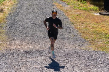 person running on a gravel path in a natural setting