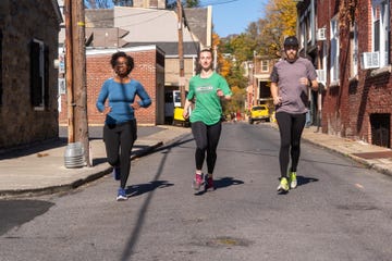 group of people jogging on a street