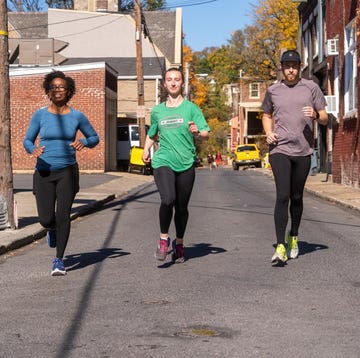 Group of people jogging on a street group of people jogging on a street