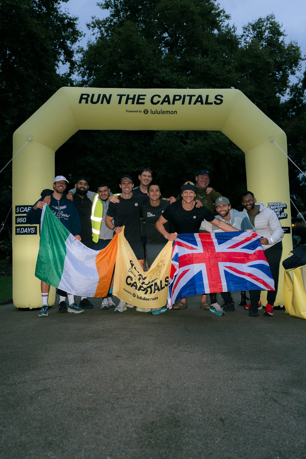 jonny davies with a group of people at the finish line of his run the capitals challenge