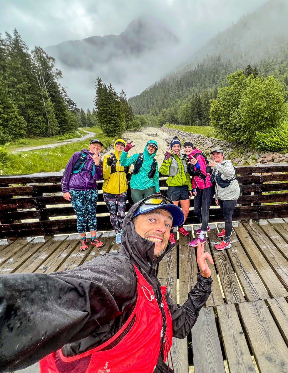group of trail runners pose for selfie in the rain