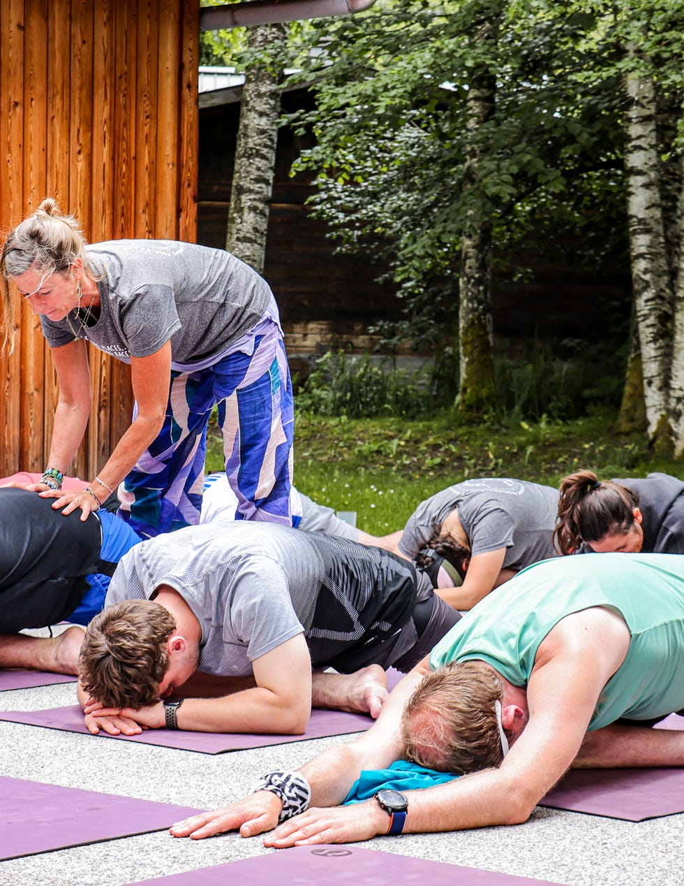 group of people doing yoga outside with yoga instructor