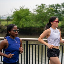 Why Every Runner Needs a Solid Base Before Race Training two women running along a river