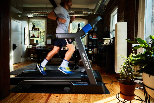 a person jogging on a treadmill in a modern indoor setting