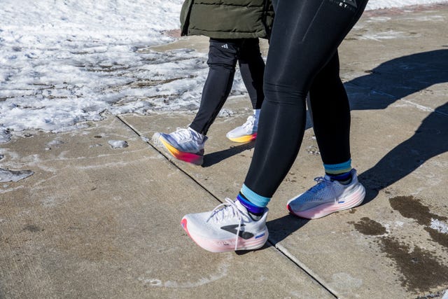 two people walking on icy sidewalk