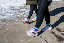 two people walking on icy sidewalk