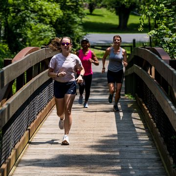 a group of people running on a bridge