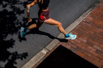a woman running in a pair of hoka running shoes