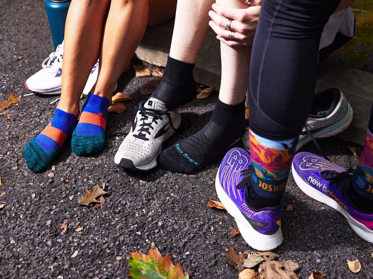 runners putting on shoes and socks