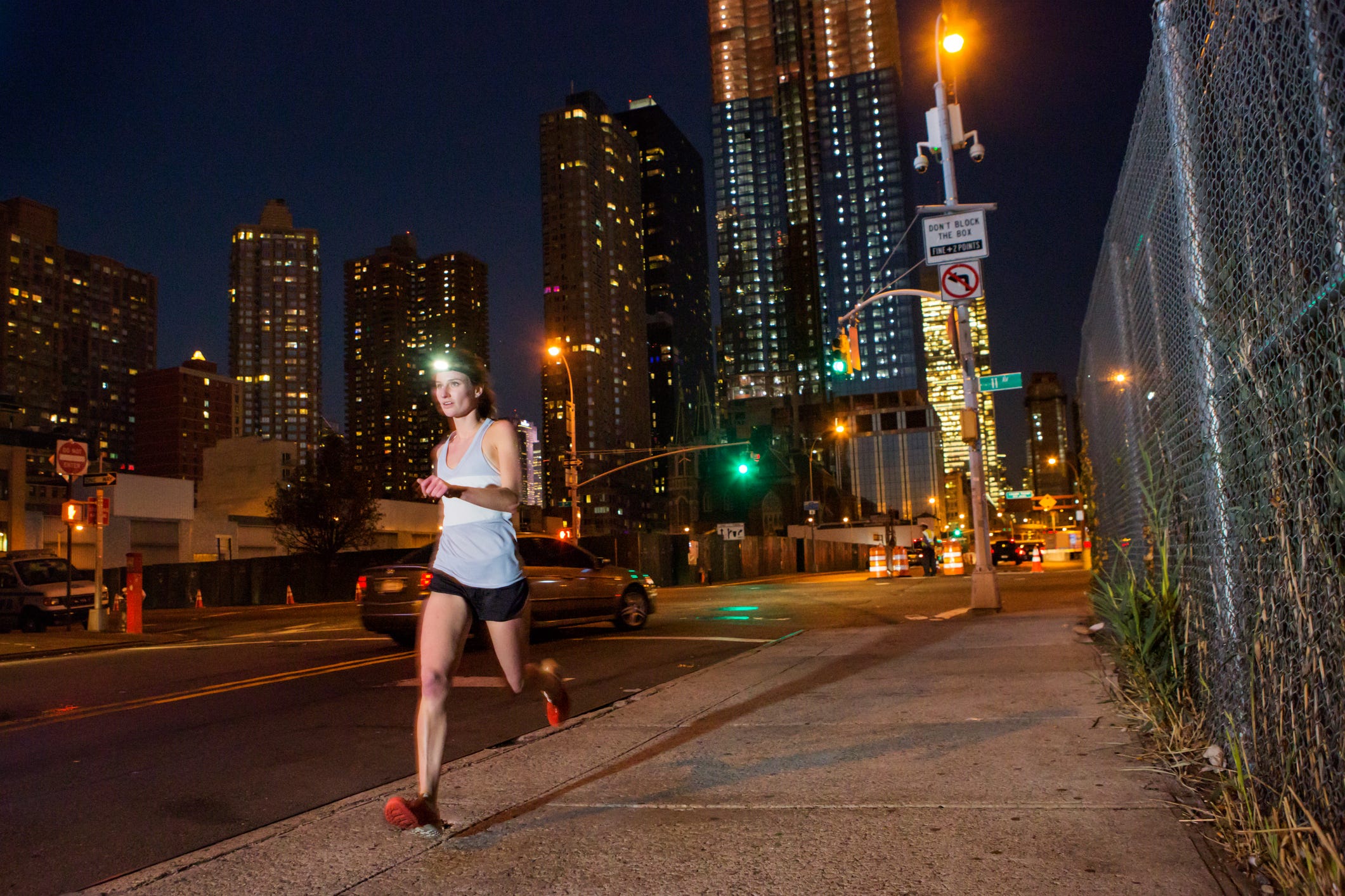 Runner at night with city in background