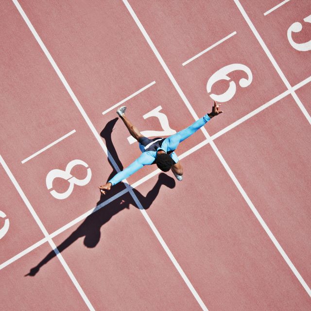 runner crossing finishing line on track