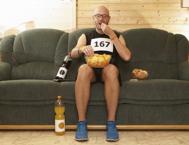 runner eating chips on sofa