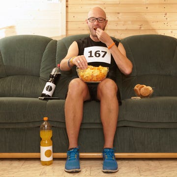 Runner eating chips on sofa Runner eating chips on sofa