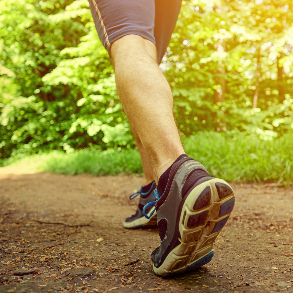 runner feet running on road closeup on shoe