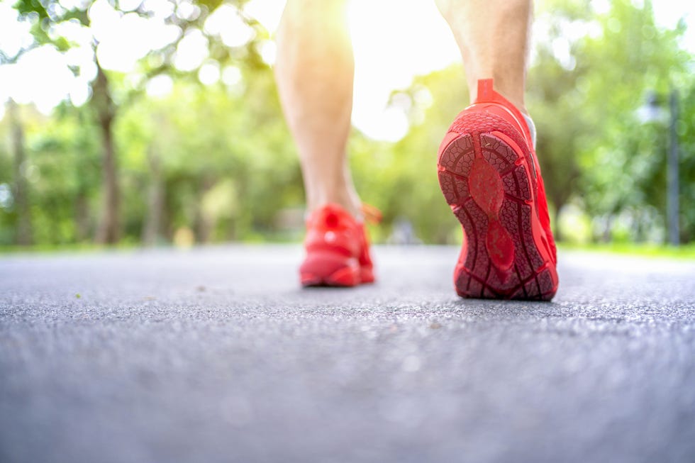 runner feet running on road closeup on shoe
