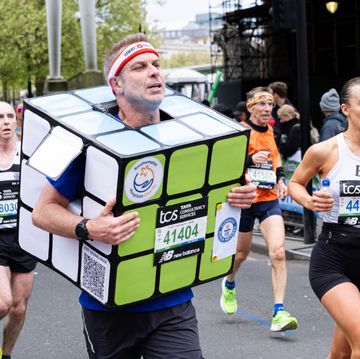 a runner in a rubik's cube costume takes part during the