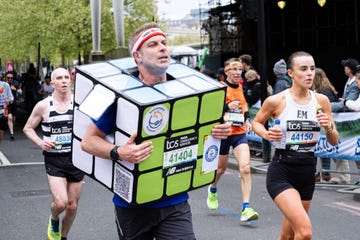 a runner in a rubik's cube costume takes part during the