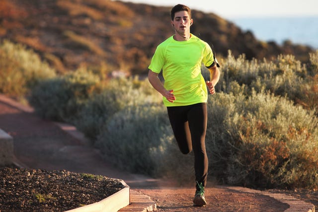 Runner on sandy road in dry environment