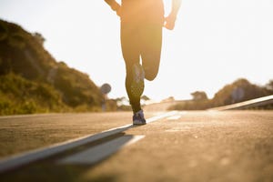 runner running on road, low section