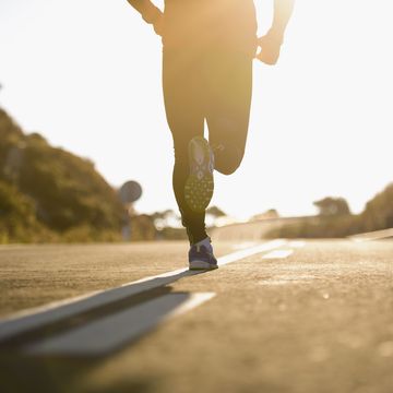 runner running on road, low section