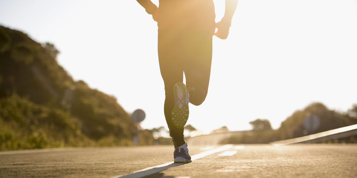 runner running on road, low section