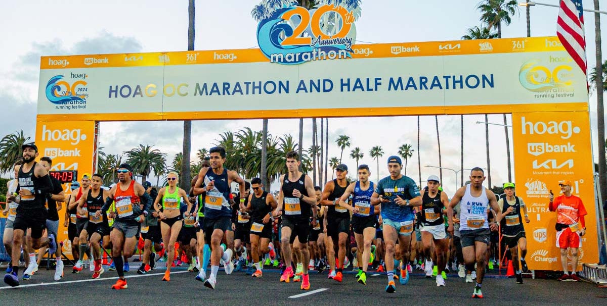 Runners starting the Hoag OC Marathon and Half Marathon under a festive arch Runners starting the Hoag OC Marathon and Half Marathon under a festive arch