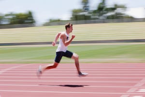 runner sprinting on track