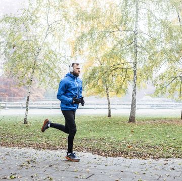 runner training in foggy park with headphones