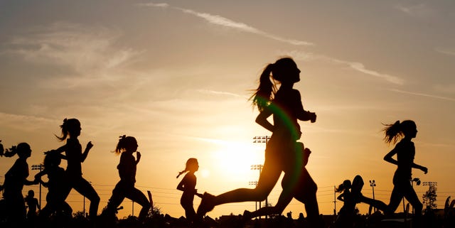 Runners compete in a 5k at sunset in Corona, California. Runners compete in a 5k at sunset in Corona, California.