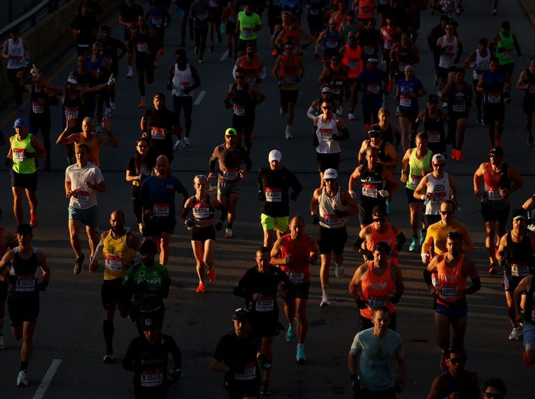 a beam of light hits a group of runners in the 2022 chicago marathon