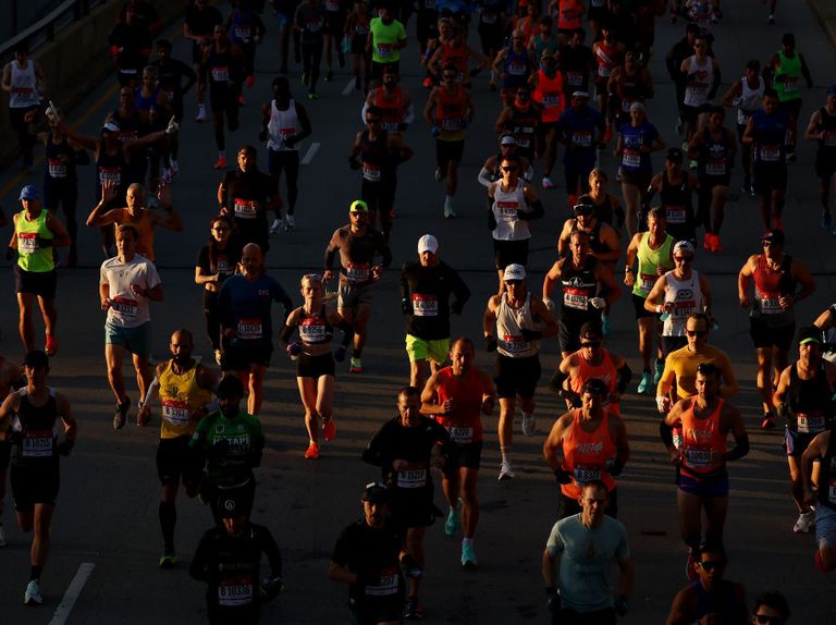 a beam of light hits a group of runners in the 2022 chicago marathon