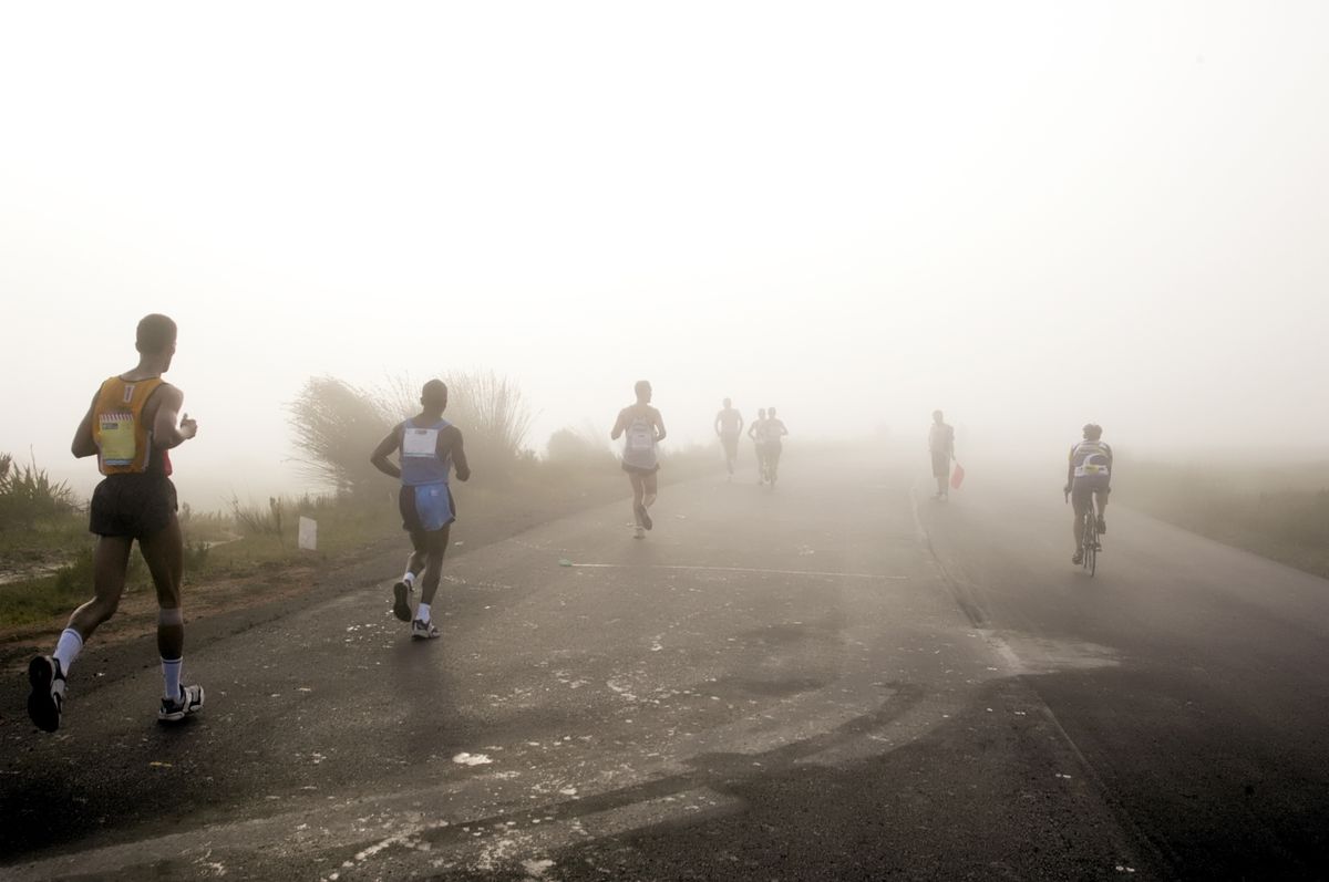 runners jogging in early morning mist