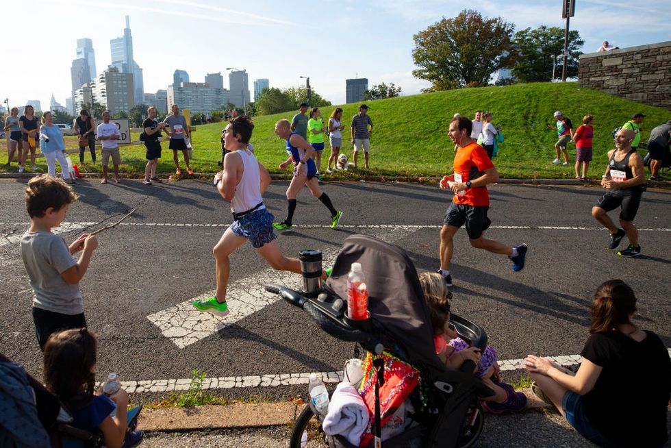 runners in the philadelphia marathon pass a spectators