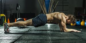 Athletic man doing the plank for abs and core