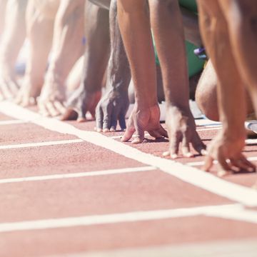 Runners poised at starting blocks on track