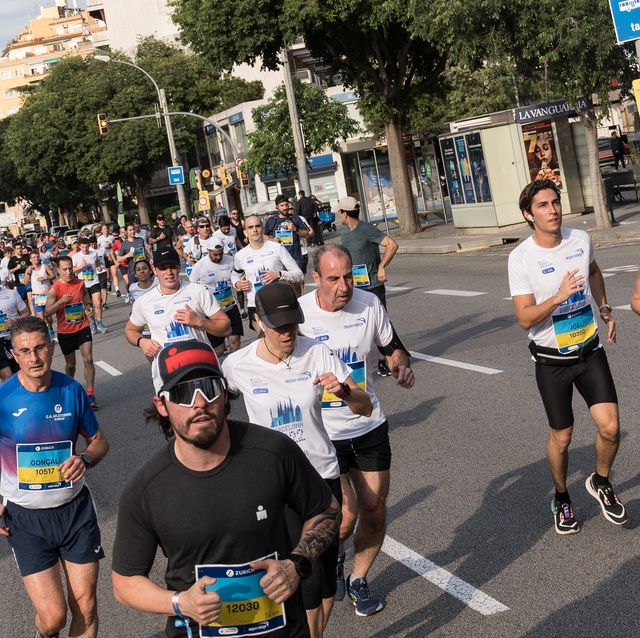 runners seen on a street of the marathon route next to the...