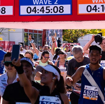 runners participating in a marathon event with timing displays for different waves runners participating in a marathon event with timing displays for different waves